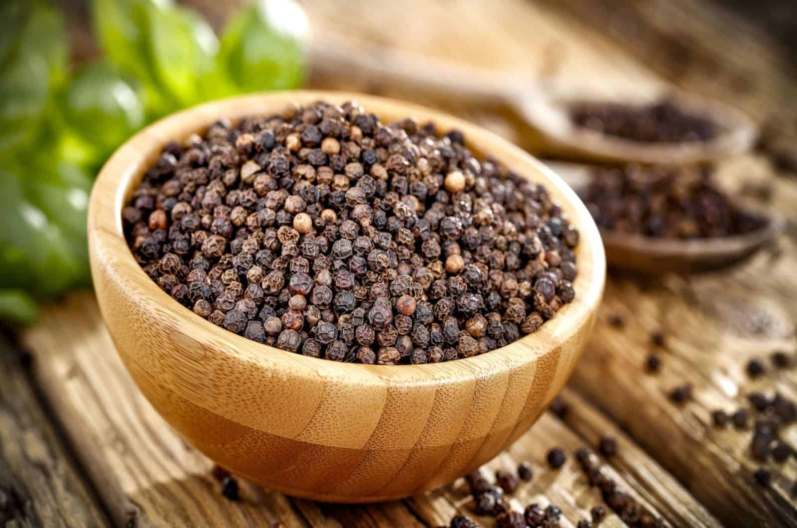 Black pepper in a wooden bowl