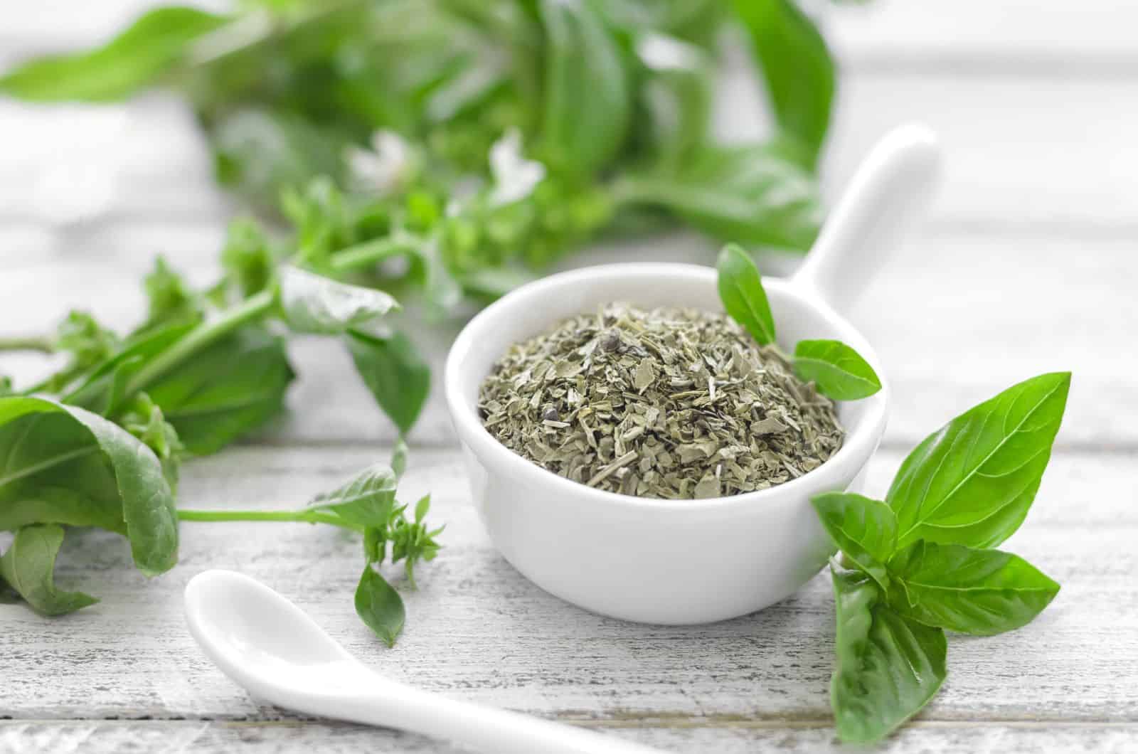 Dried basil in little white spoon