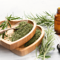 Natural rosemary essential oil with fresh rosemary twigs