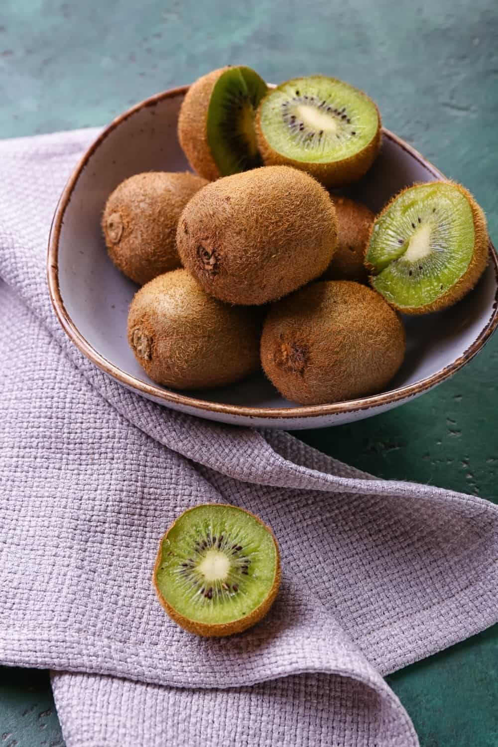 Bol avec kiwi frais sur fond vert