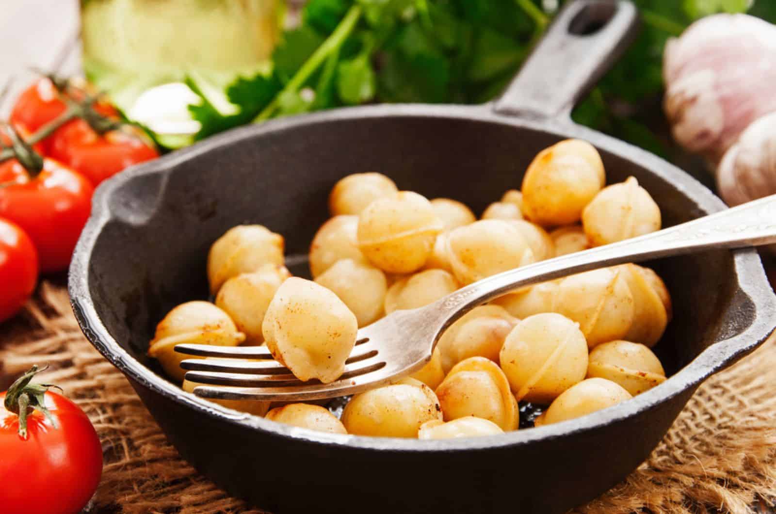 Delicious dumplings in the frying pan on the table