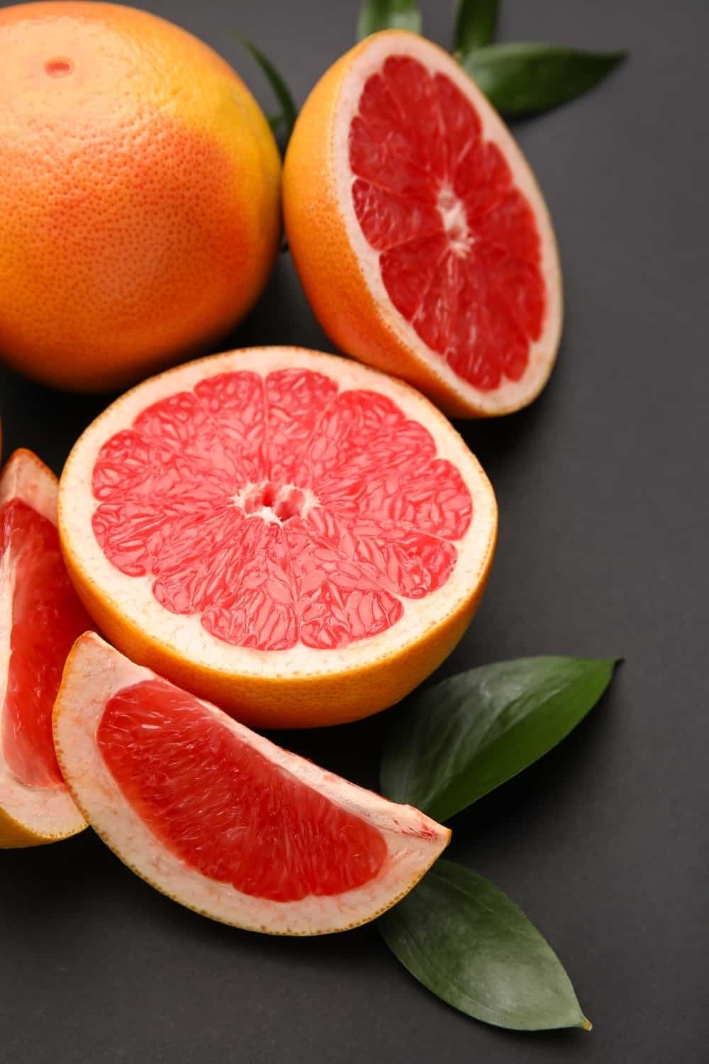 Fresh grapefruits on dark background