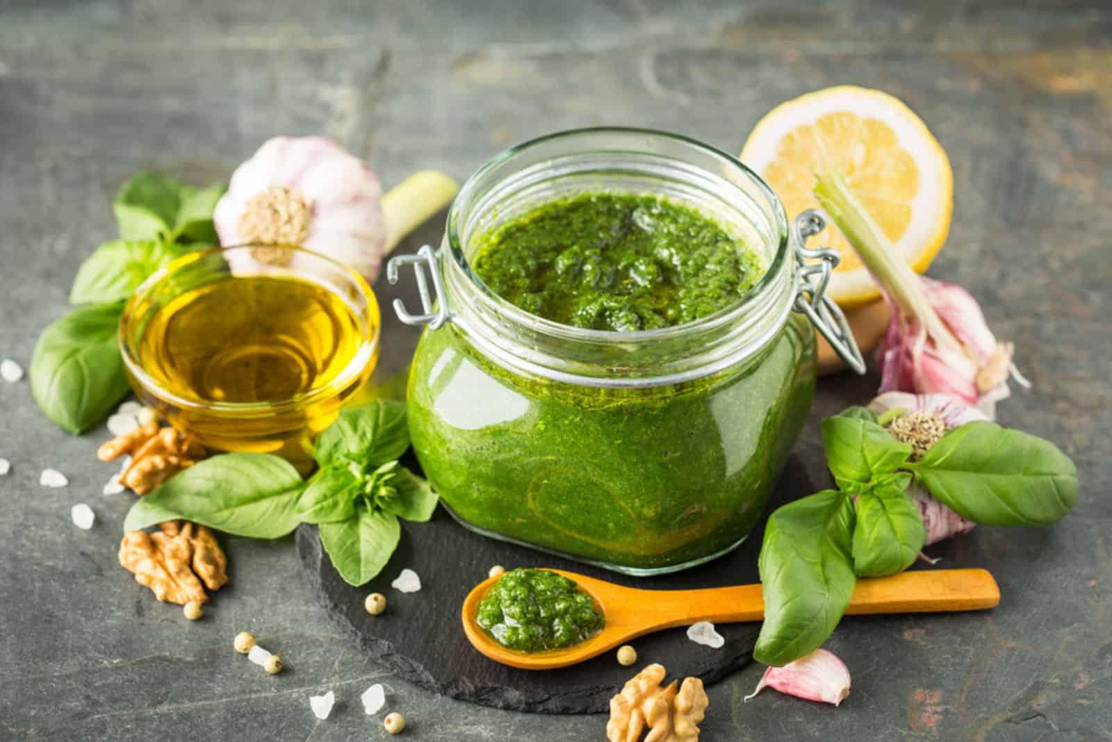 Fresh pesto sauce and ingredients in the glass jar