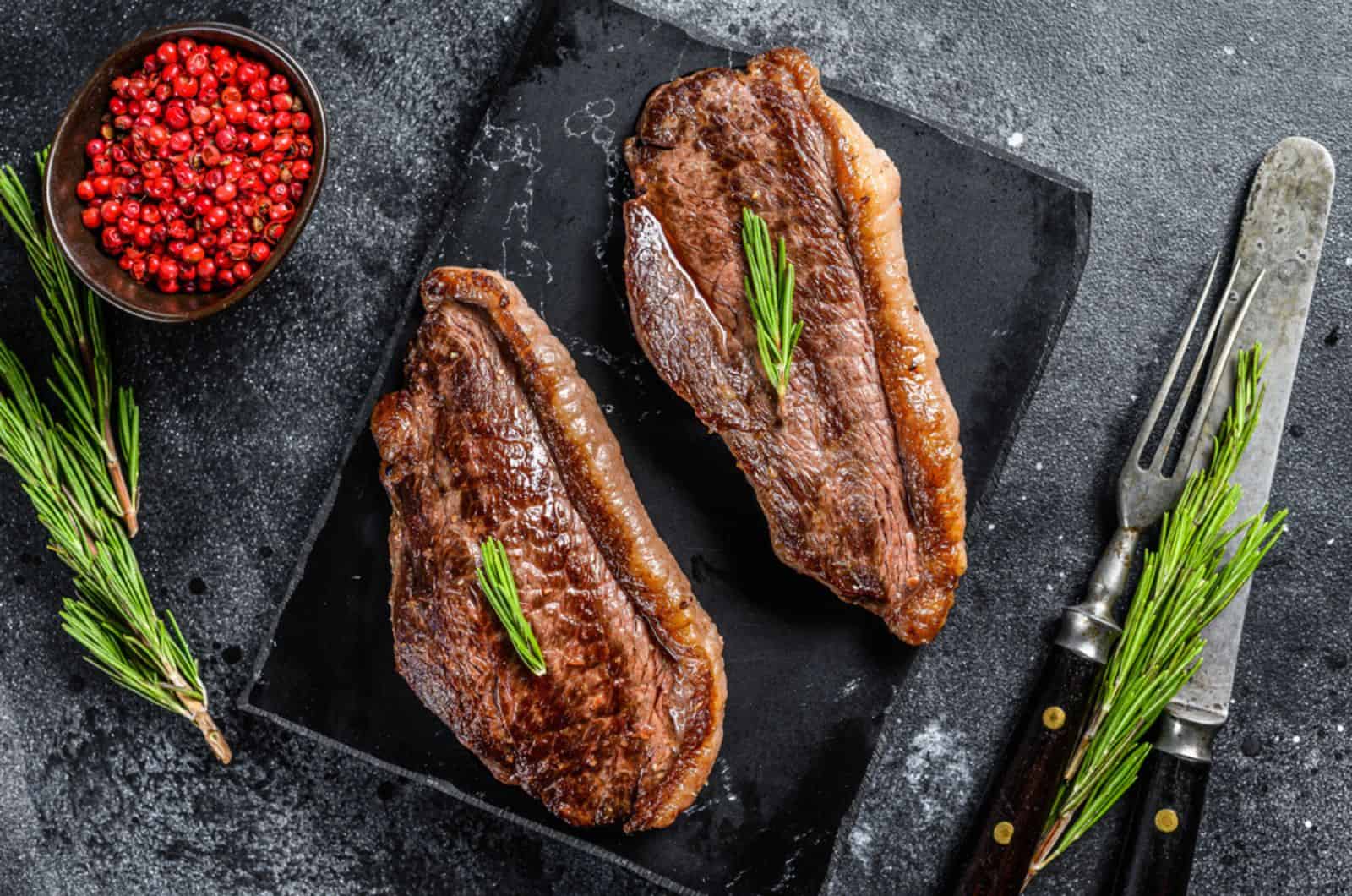 Grilled top sirloin cap or picanha steak on a stone chopping Board