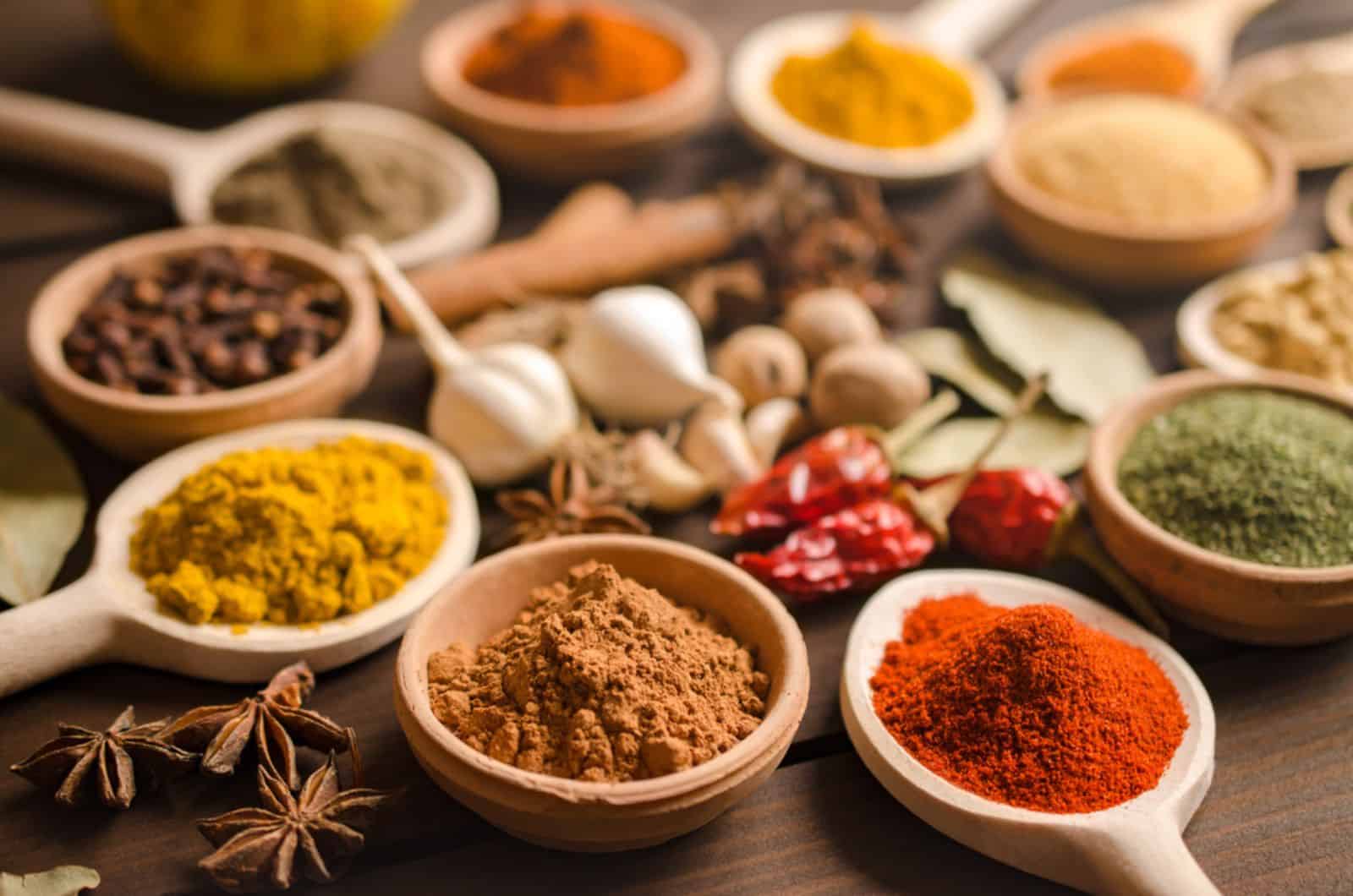 Indian spices and dried herbs on wooden table