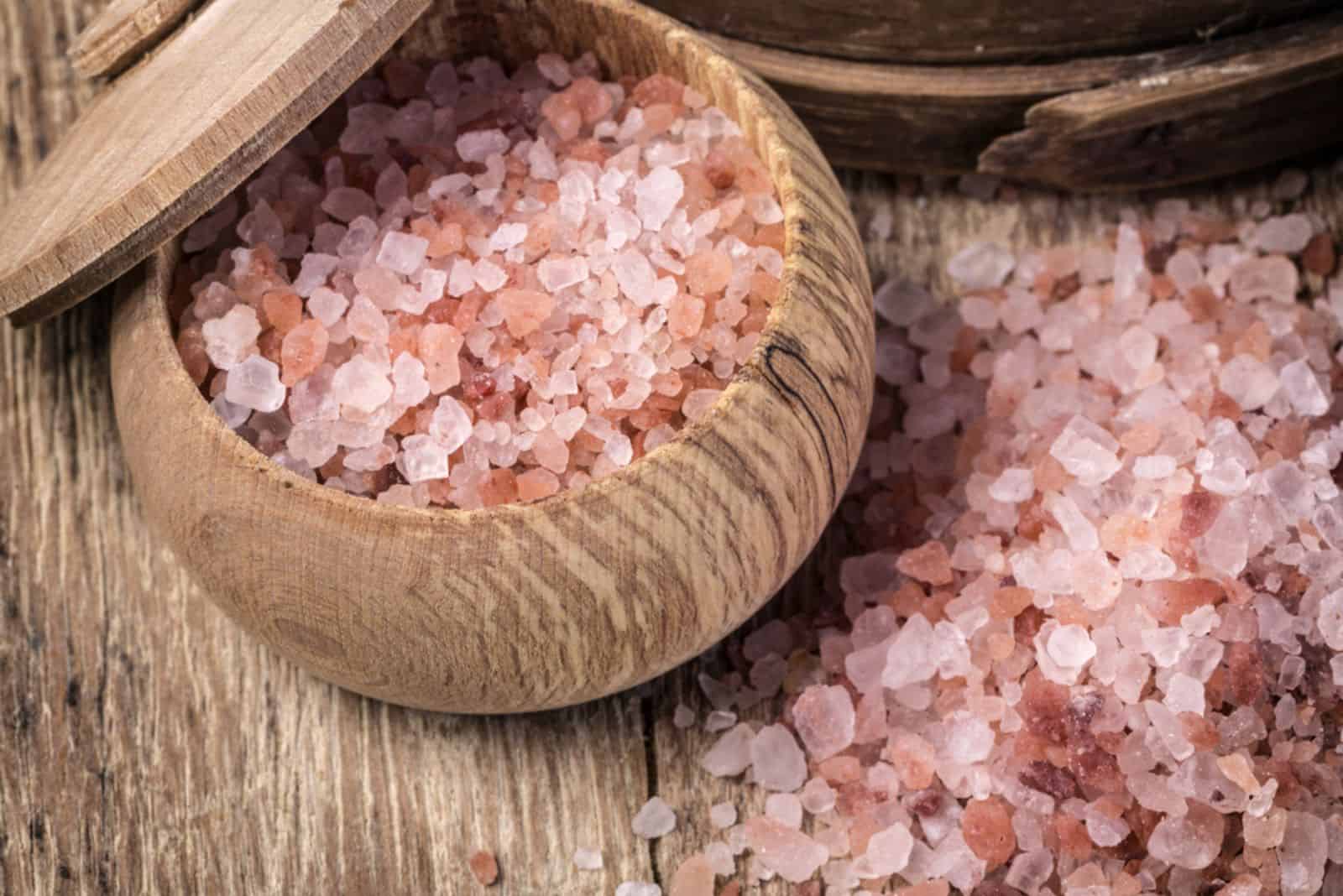 Pink salt from the Himalayas on wooden background