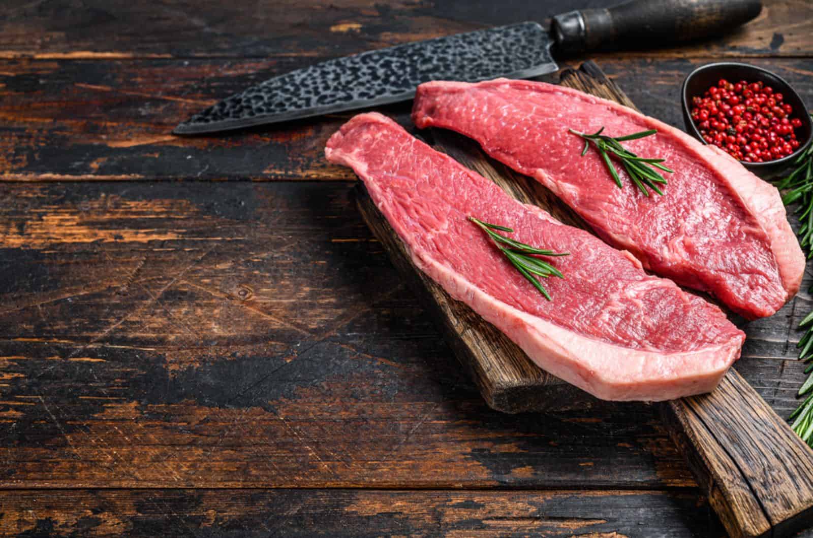 Raw beef meat cap sirloin steak on a cutting board