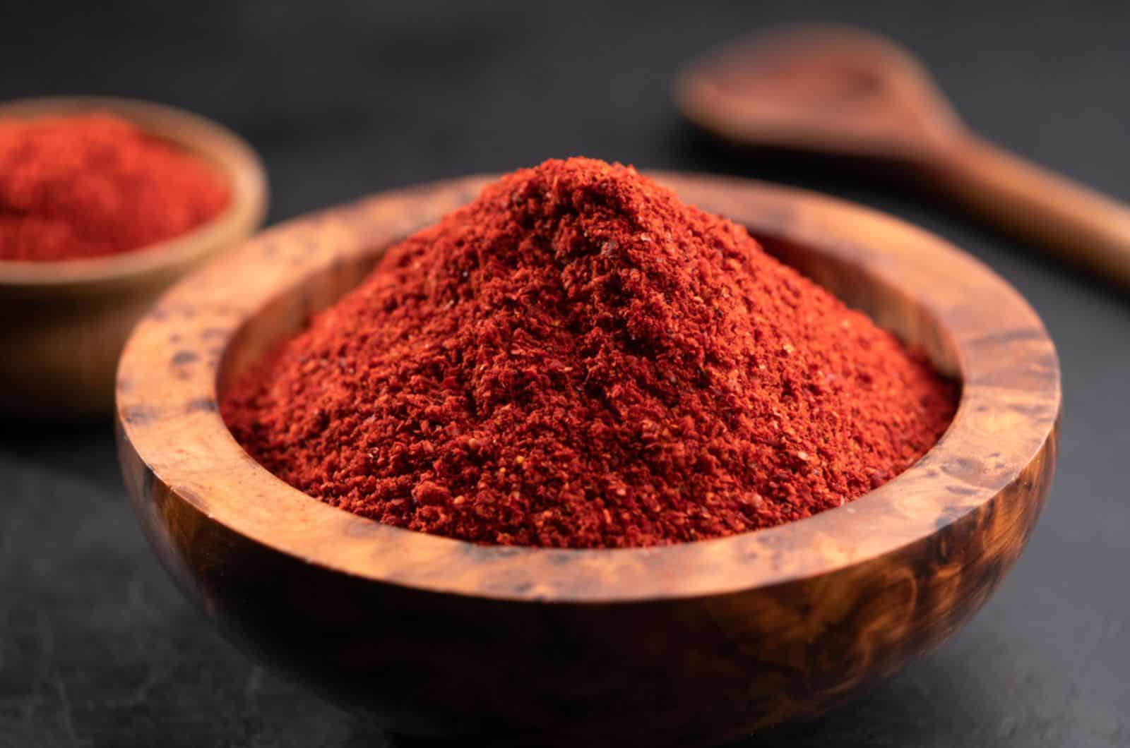 Red chili powder or paprika in a wooden bowl 