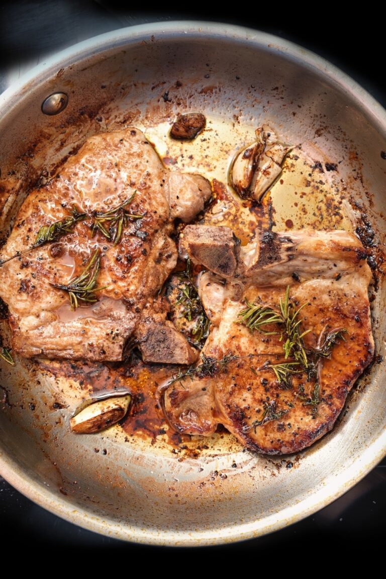 8 Best Ways To Reheat Pork Chops And 6 Common Mistakes To Avoid   Roasted Pork Chops With Herbs Spices And Garlic In A Frying Pan 768x1152 