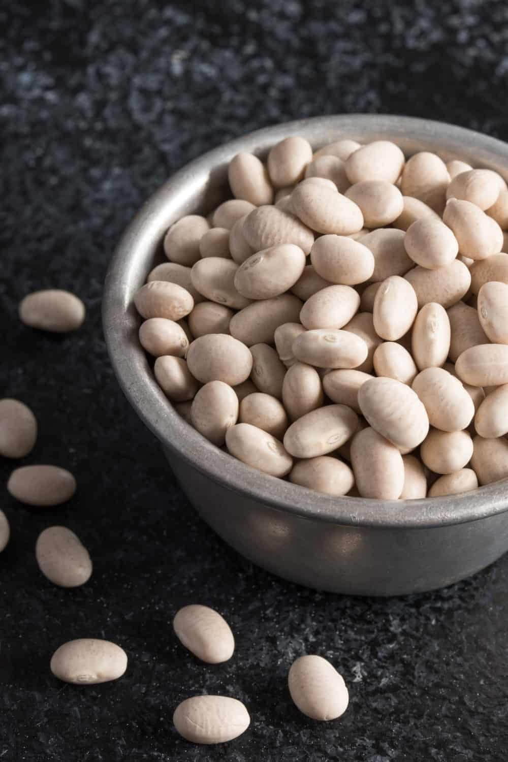 Uncooked Navy Beans Spilled from a Measuring Cup