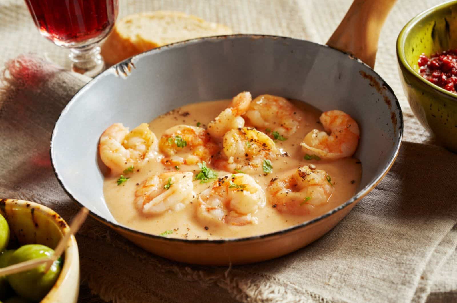 shrimps in cheese-cream sauce or kase sahne sauce served in an old small pan