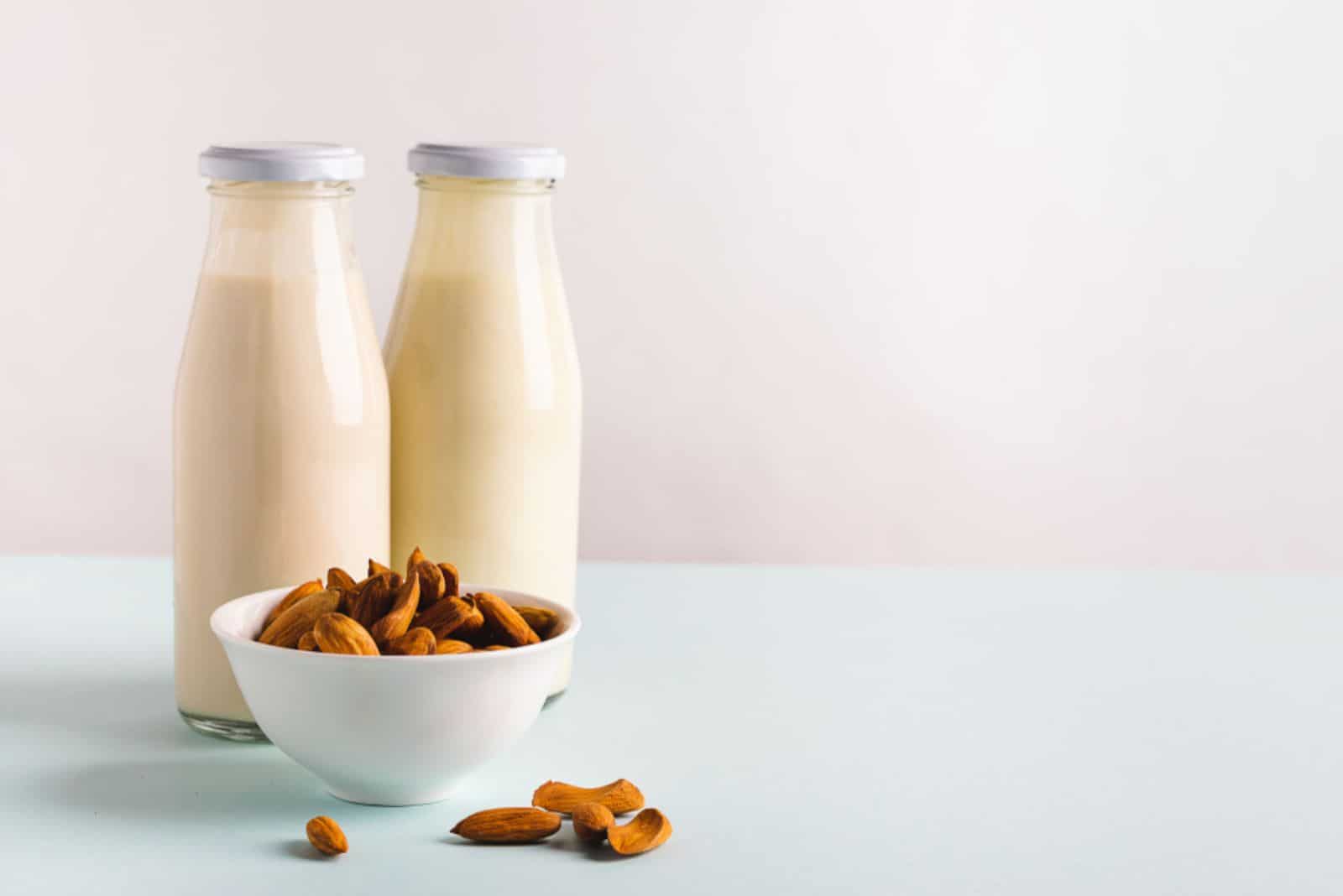 Almond nut milk drink in glass bottles