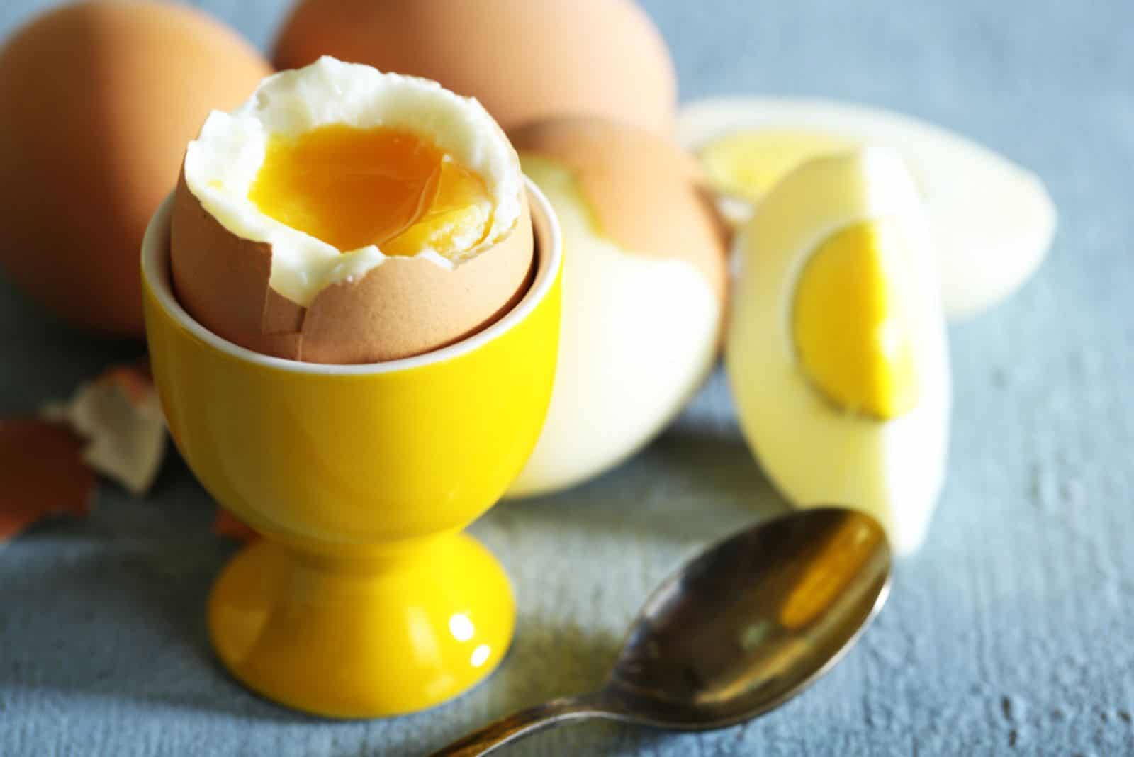 Boiled eggs on color wooden background