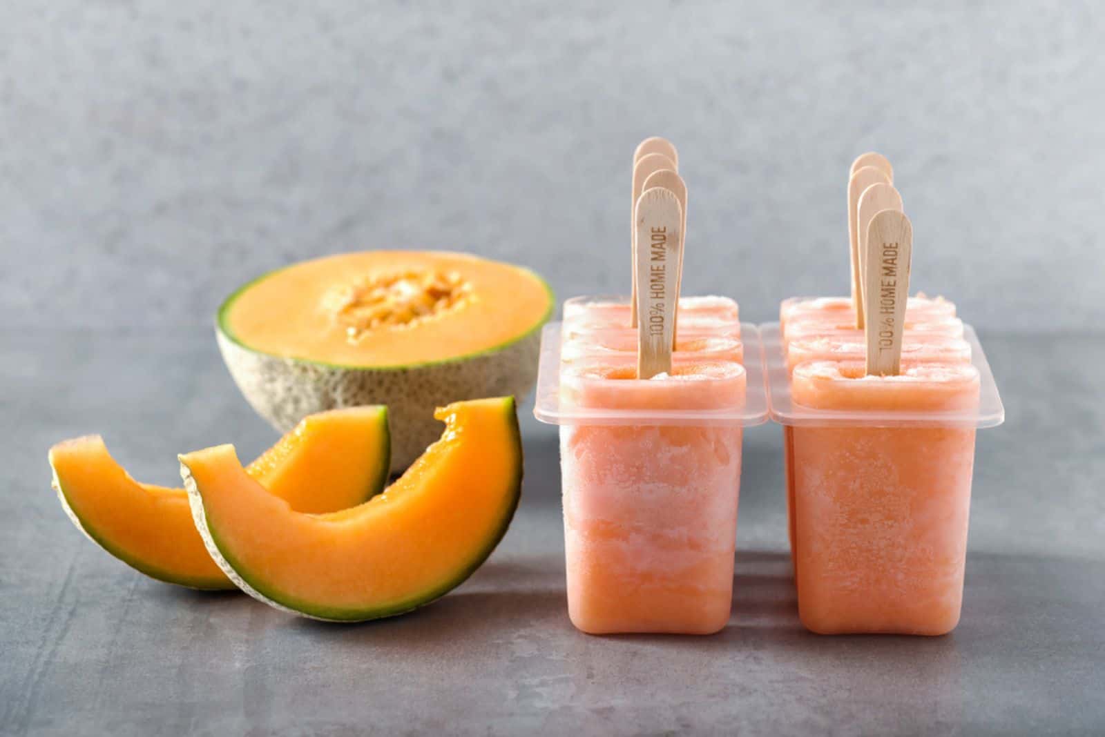 Homemade cantaloupe melon popsicles with fresh slices