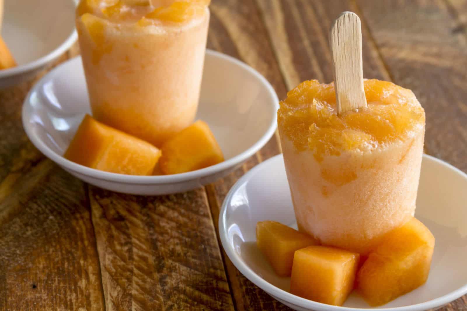 Homemade fresh pureed frozen cantaloupe melon popsicles