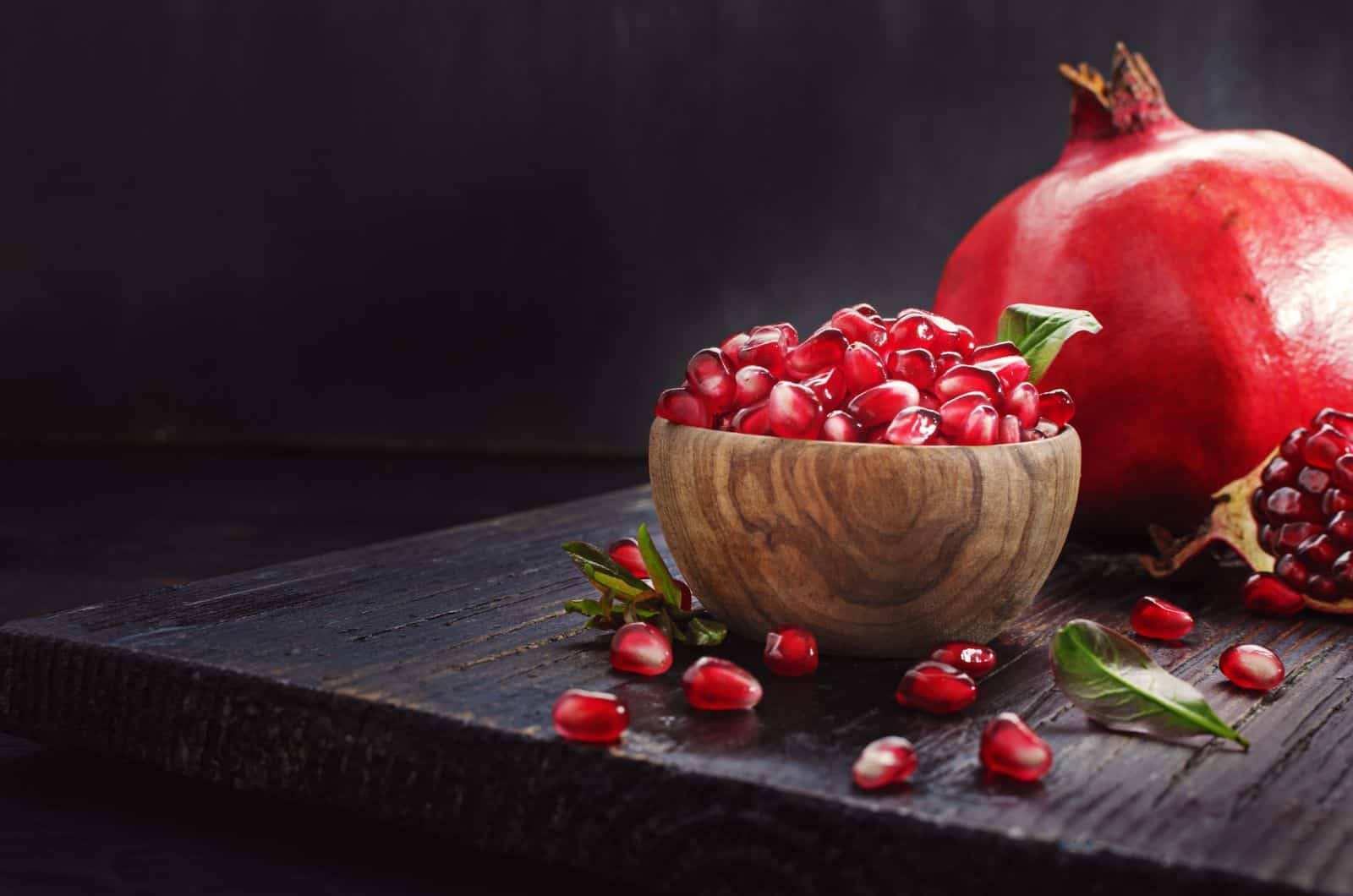 Pomegranate Seeds in bowl on black table