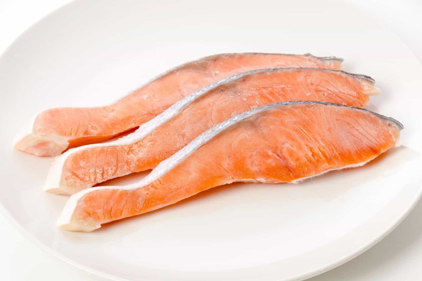 Raw Coho Salmon fillet on white plate