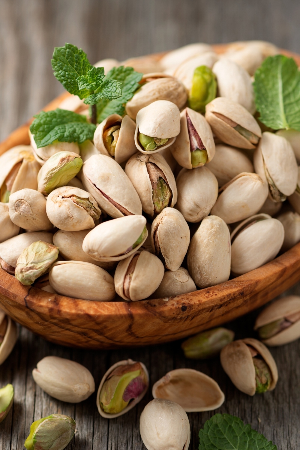 pistachios in a wooden bowl on the table
