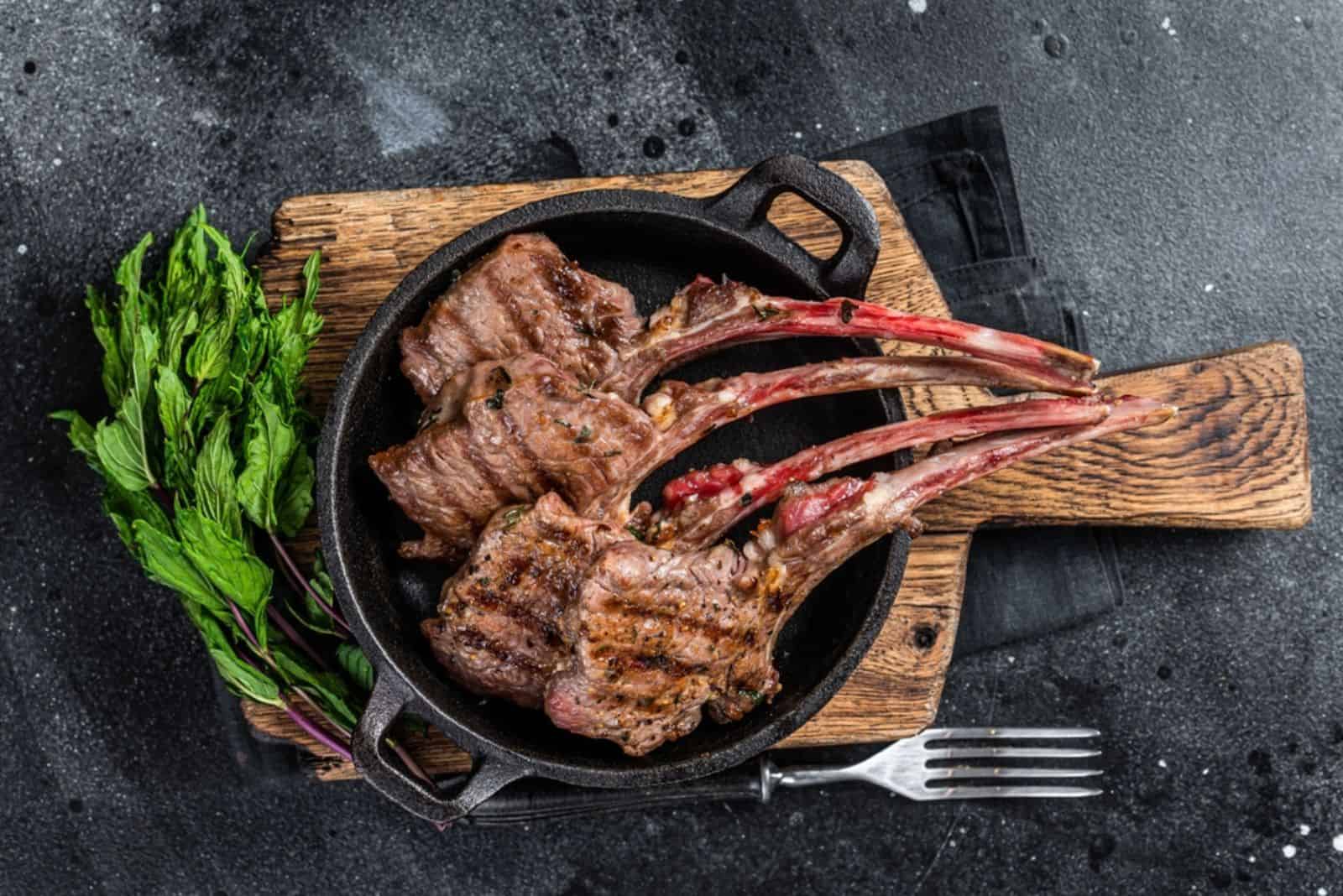 Grilled lamb mutton chops steaks in a pan
