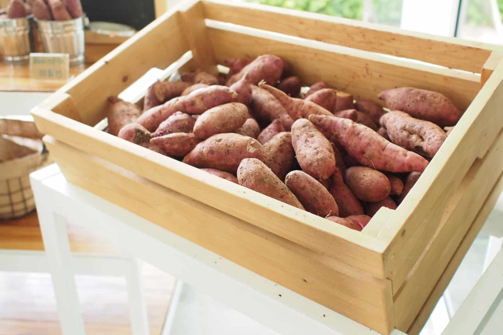 Many sweet potatoes in the wooden crate