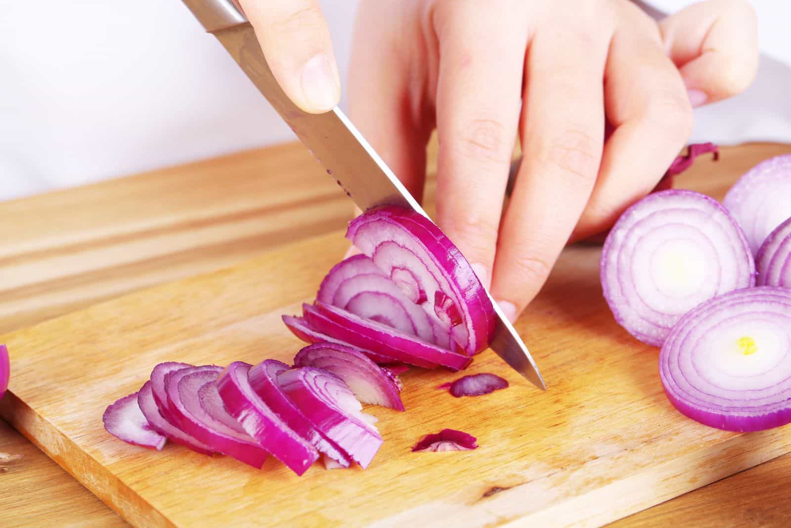a woman cuts an onion