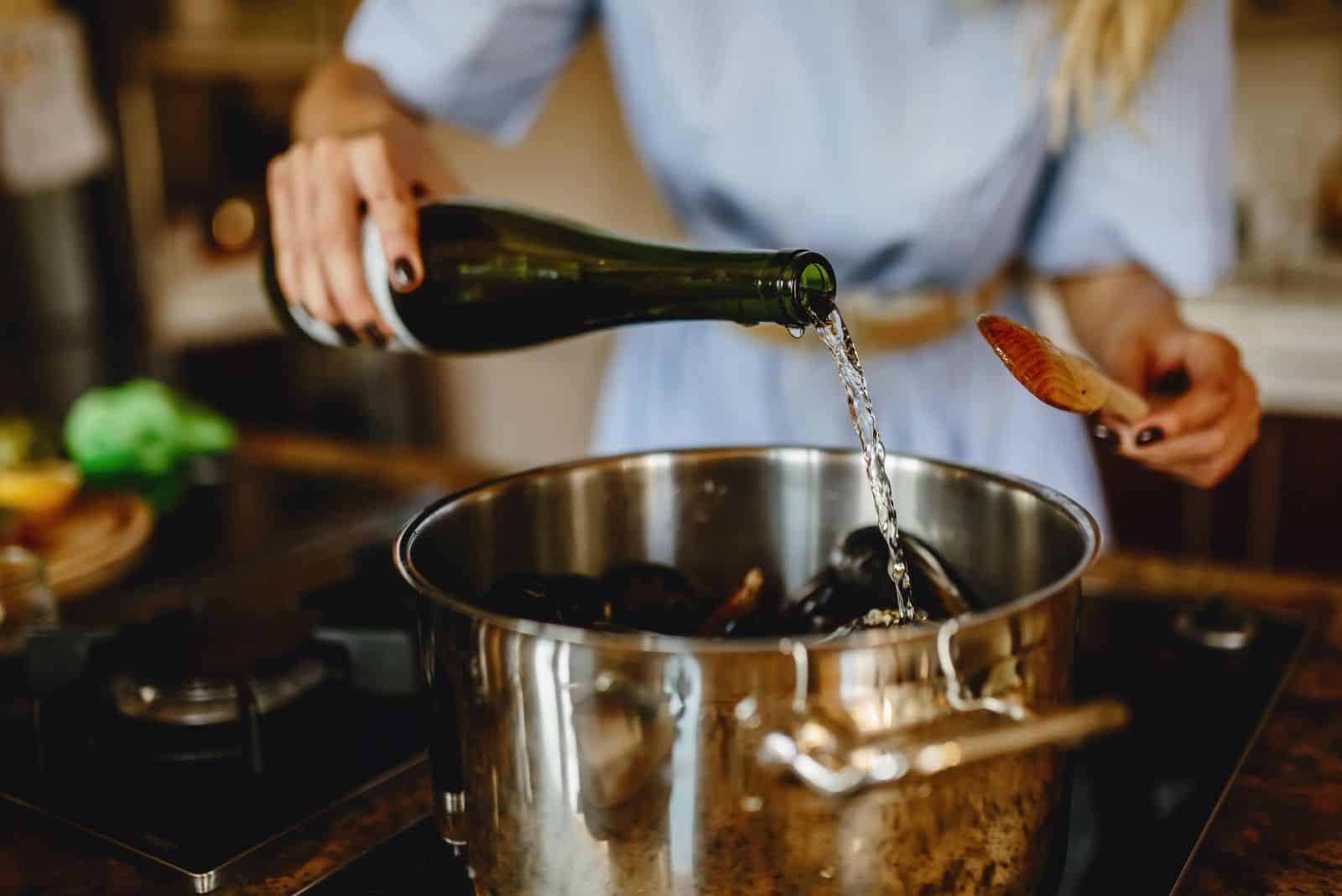 adding white wine to the soup