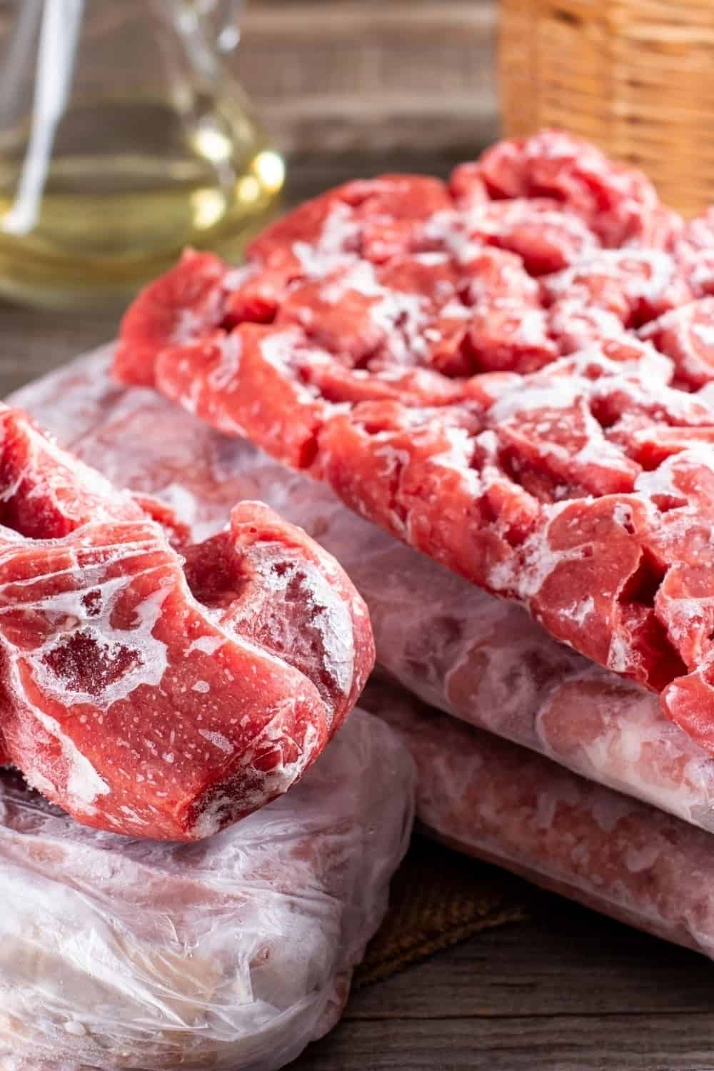 different kinds of frozen meat on a wooden table