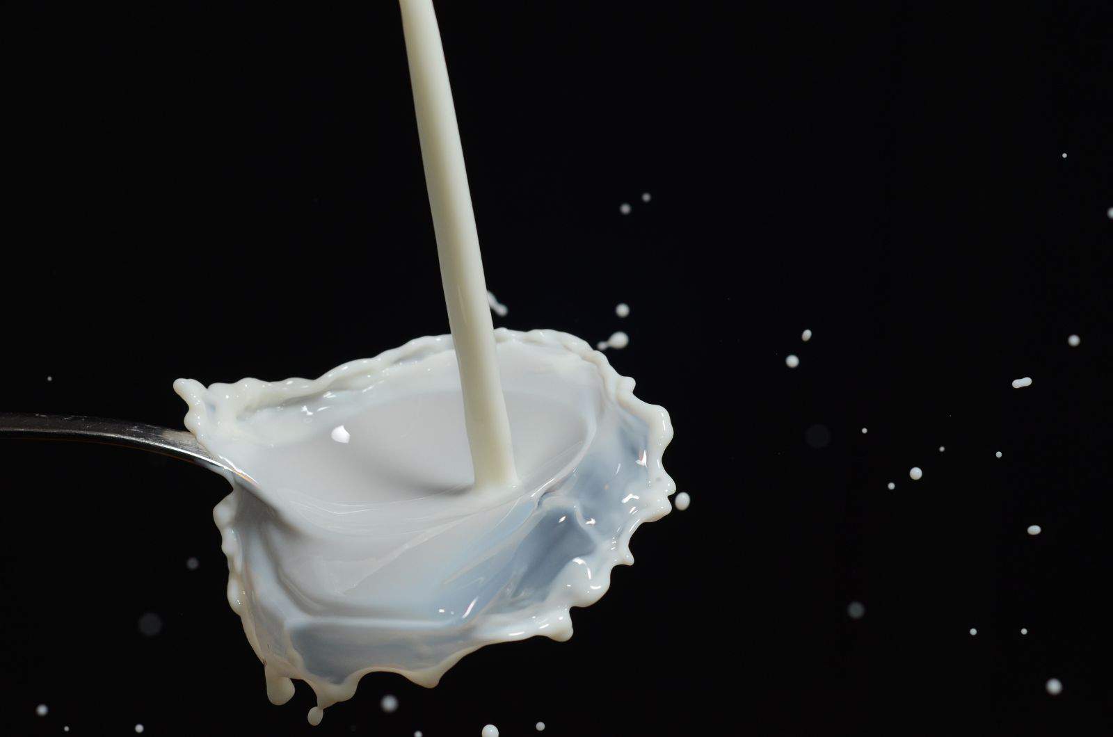 pouring milk on black table