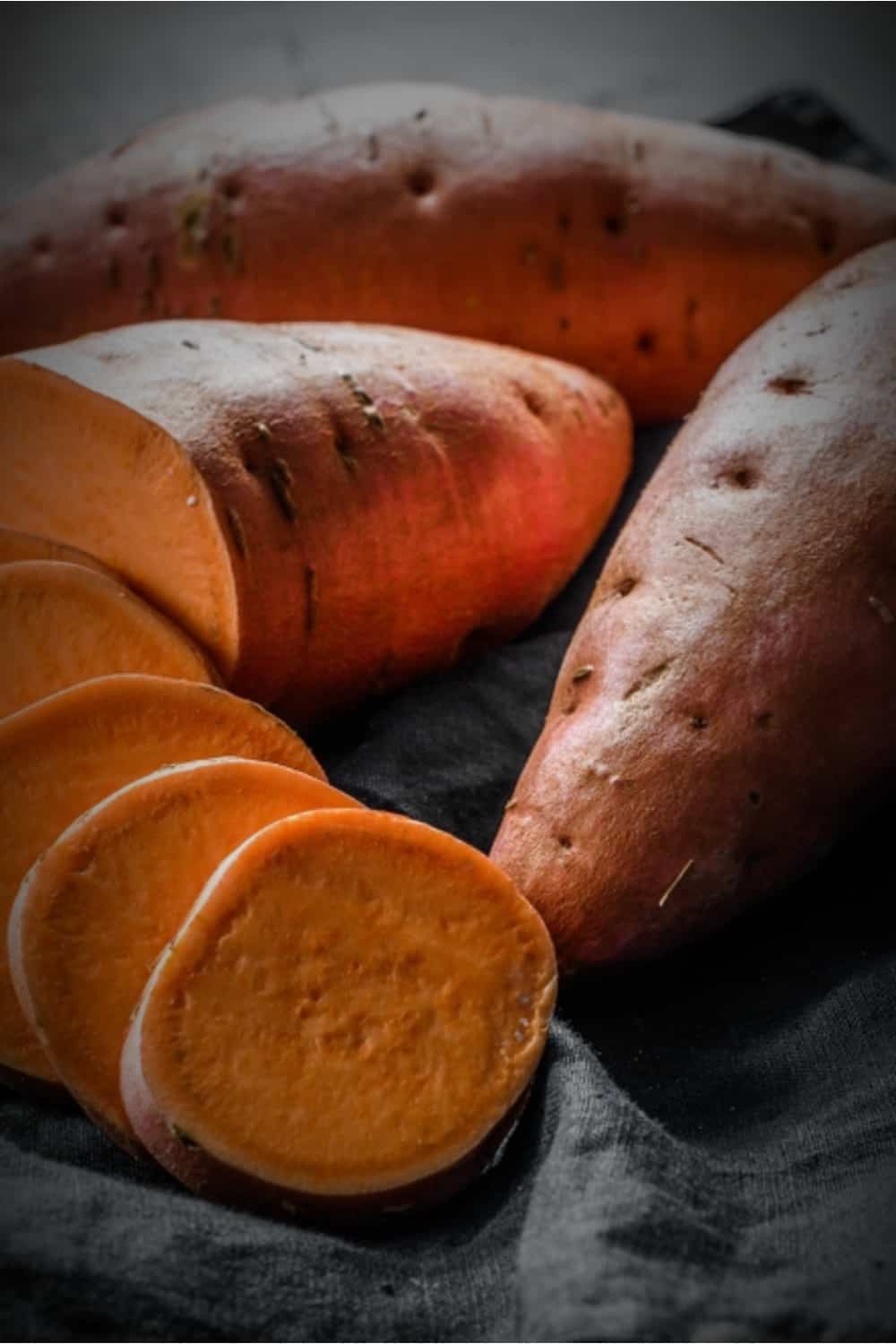 sweet potatoes on a black cloth