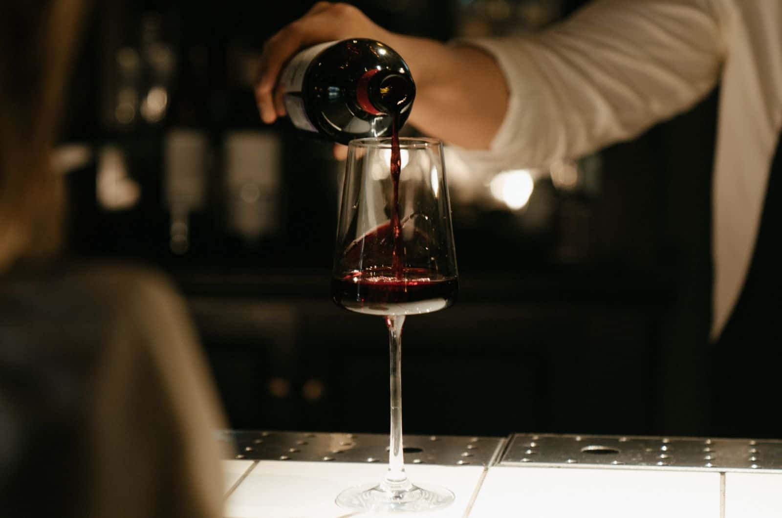 waiter pouring red wine