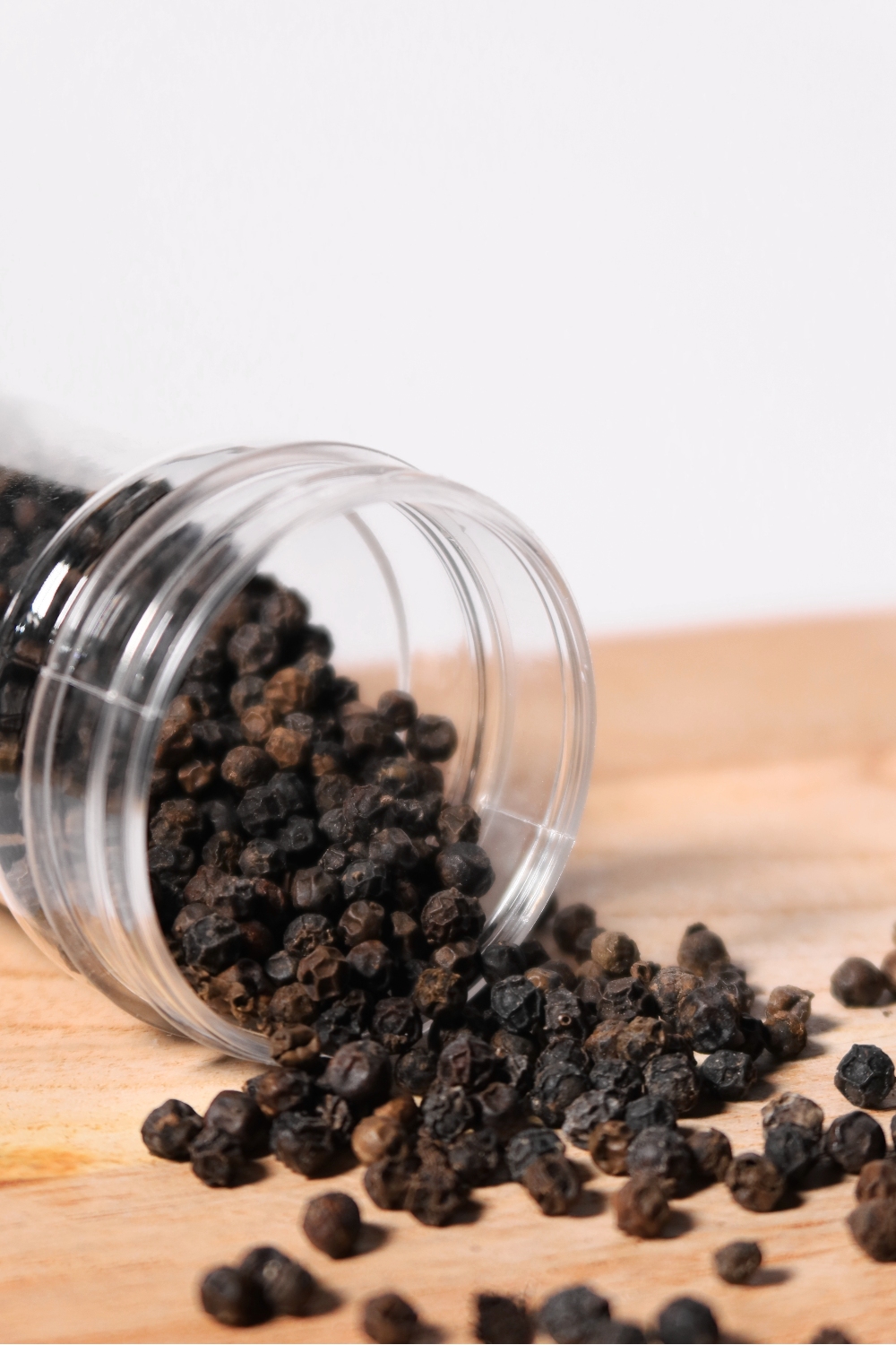 black pepper spilled on a cutting board