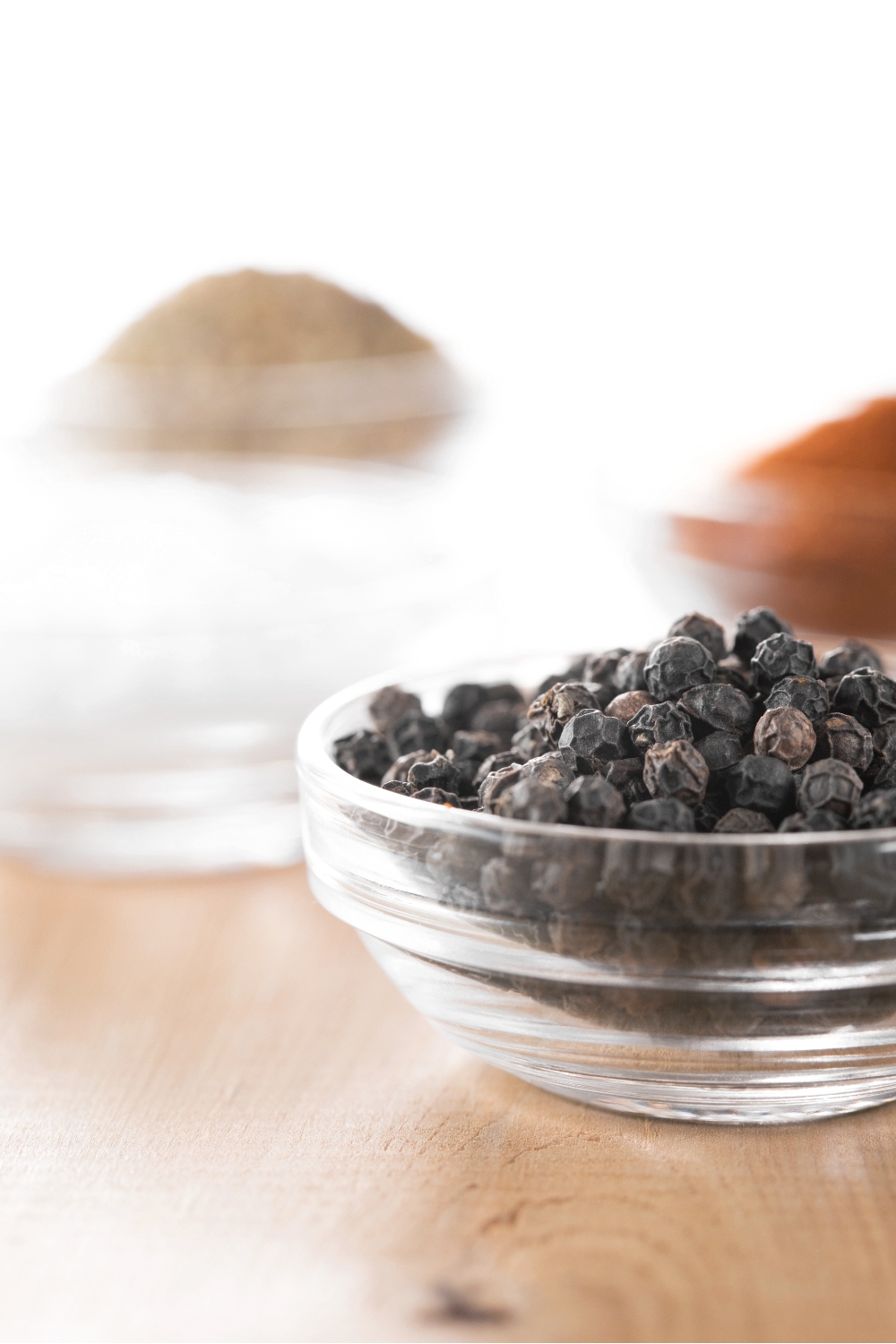 photo of black pepper in a glass bowl