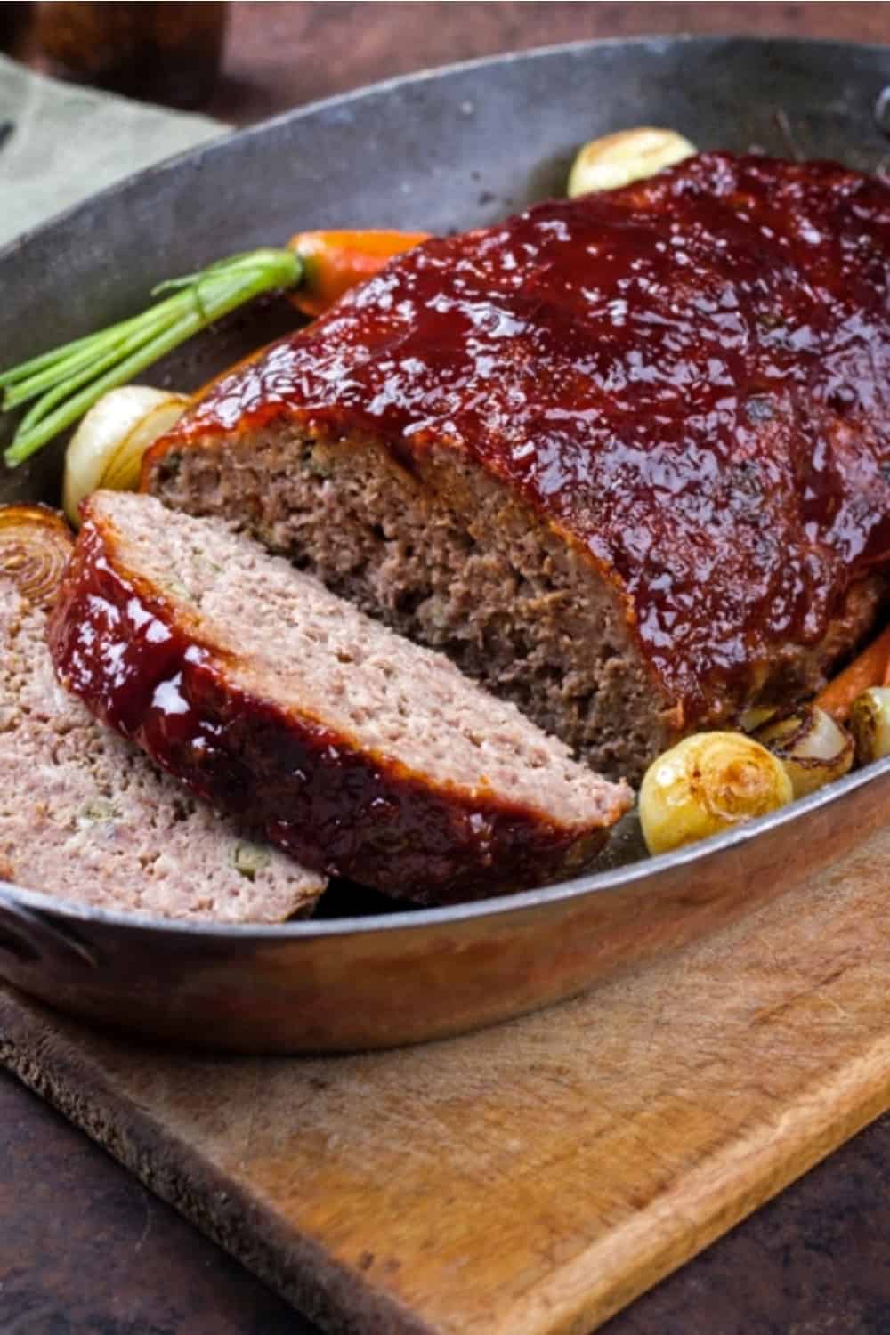 rolled meatloaf in pan with vegetables