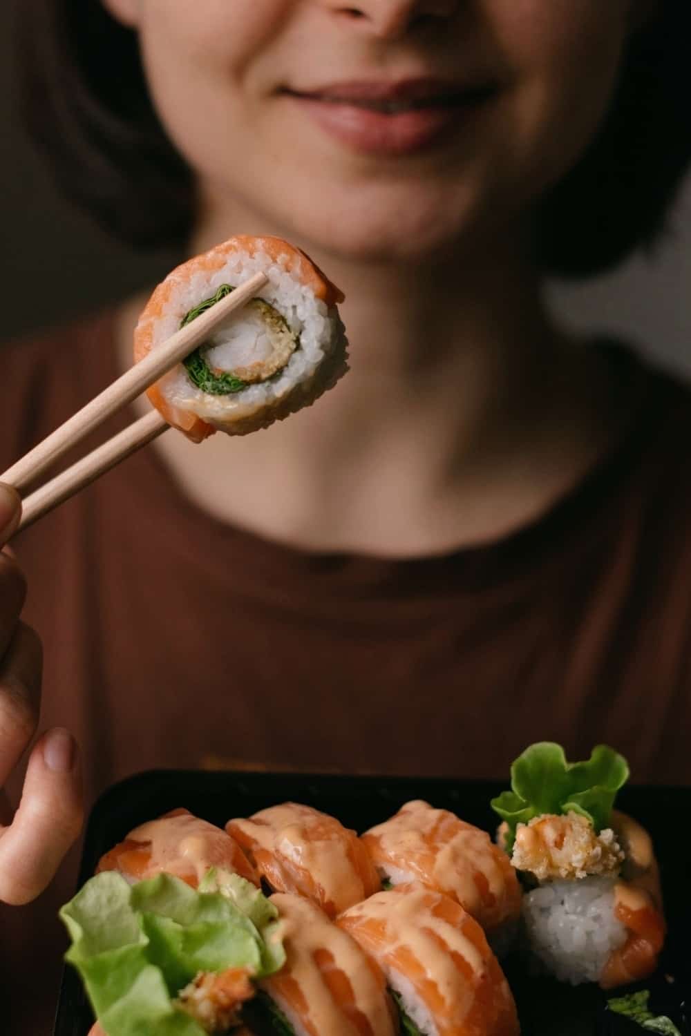 woman eating Sushi