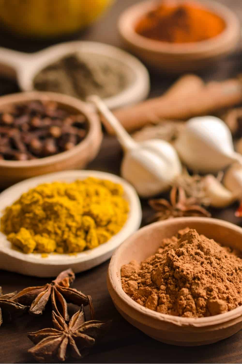 Indian spices and dried herbs on wooden table (2)