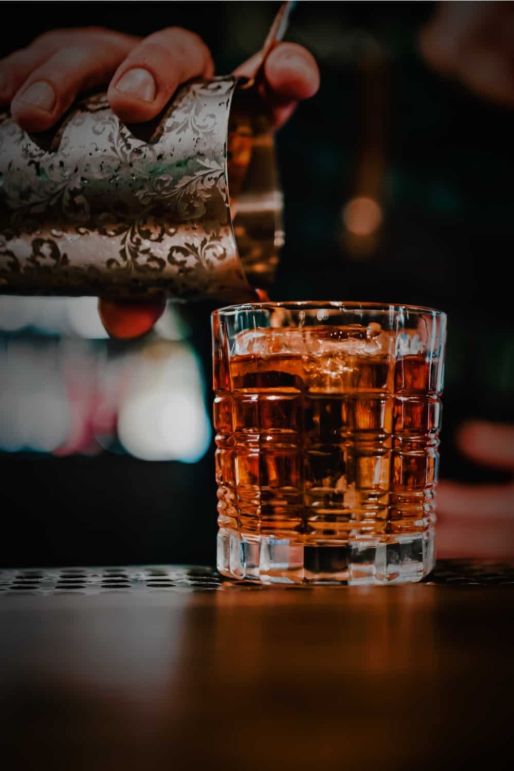 a man pours Vermouth into a glass