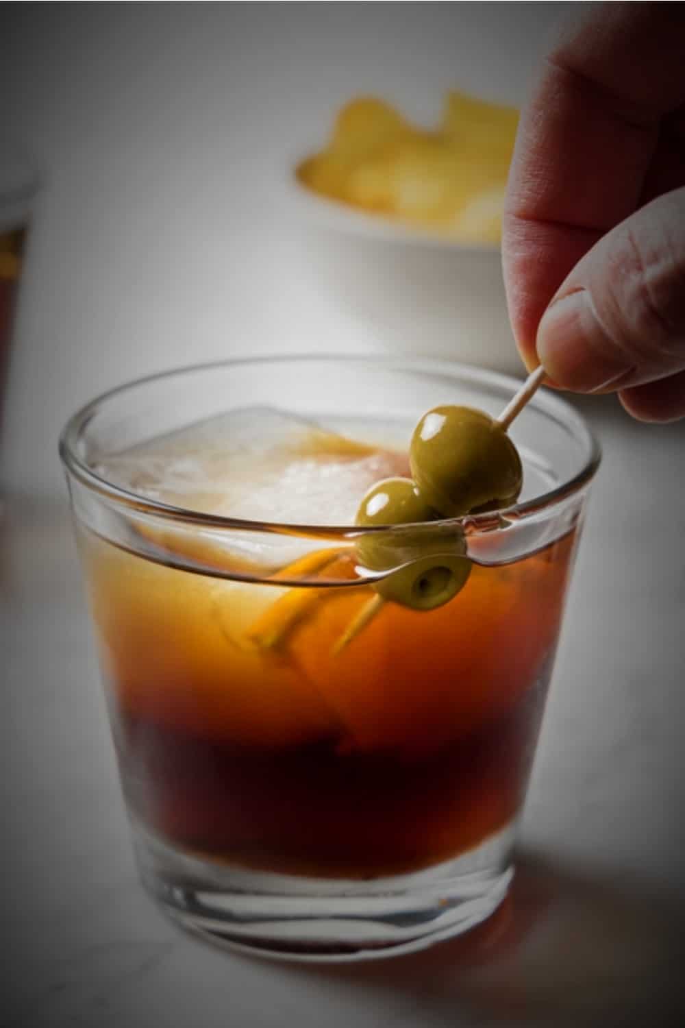 a man puts olives in the Vermouth class