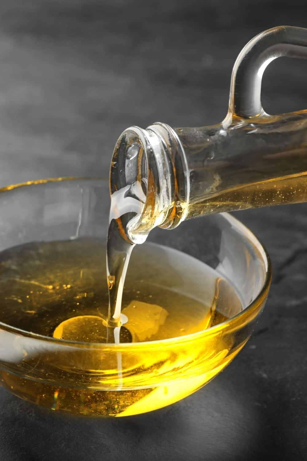 canola oil being poured into a small bowl