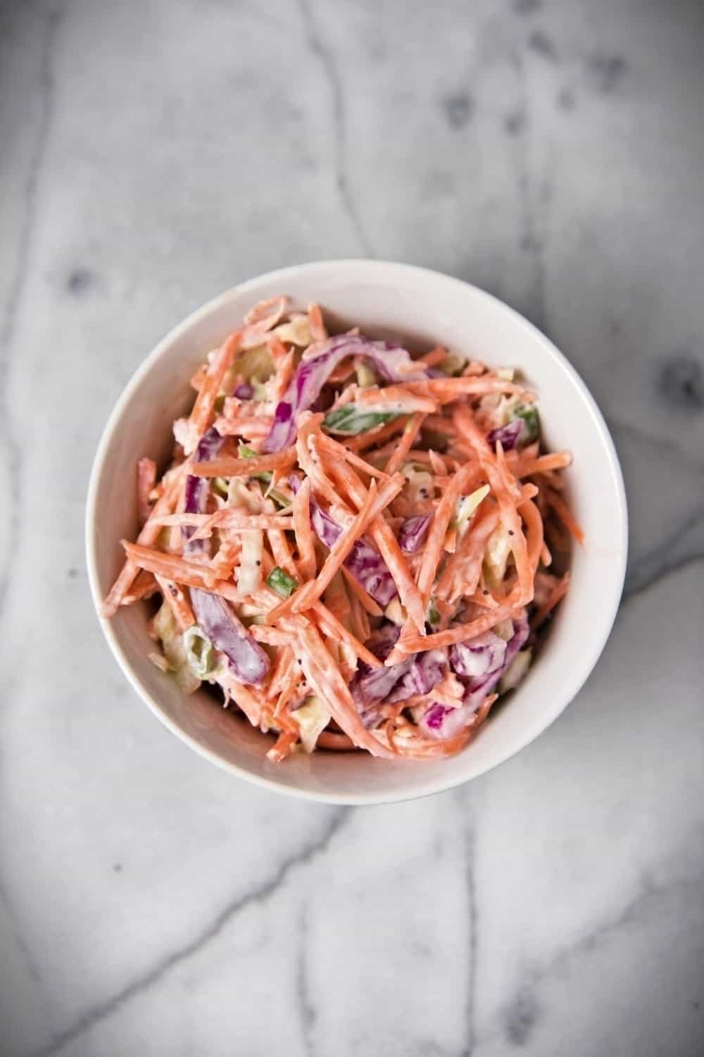 coleslaw in a bowl on marble table