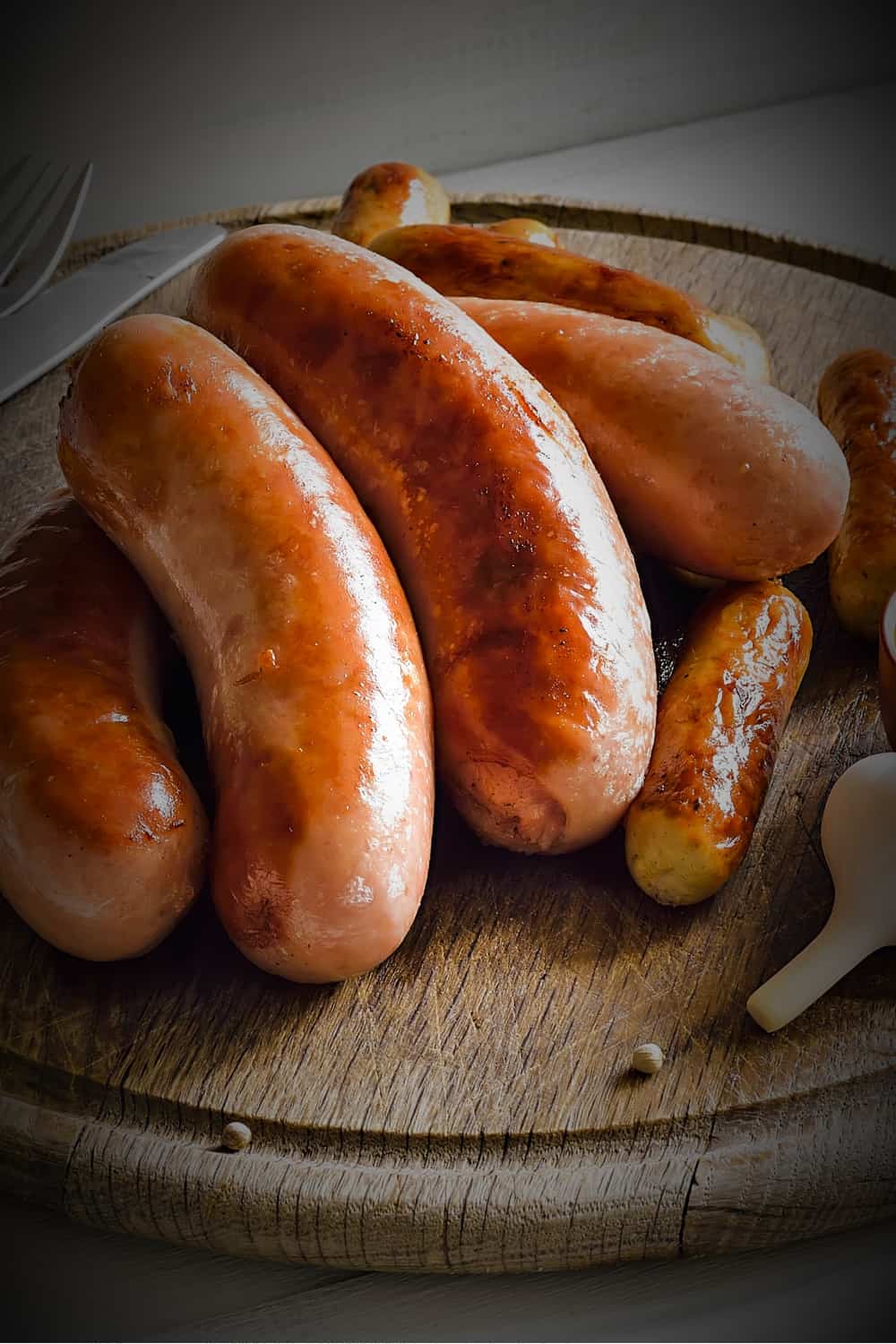 cooked sausages on a wooden board