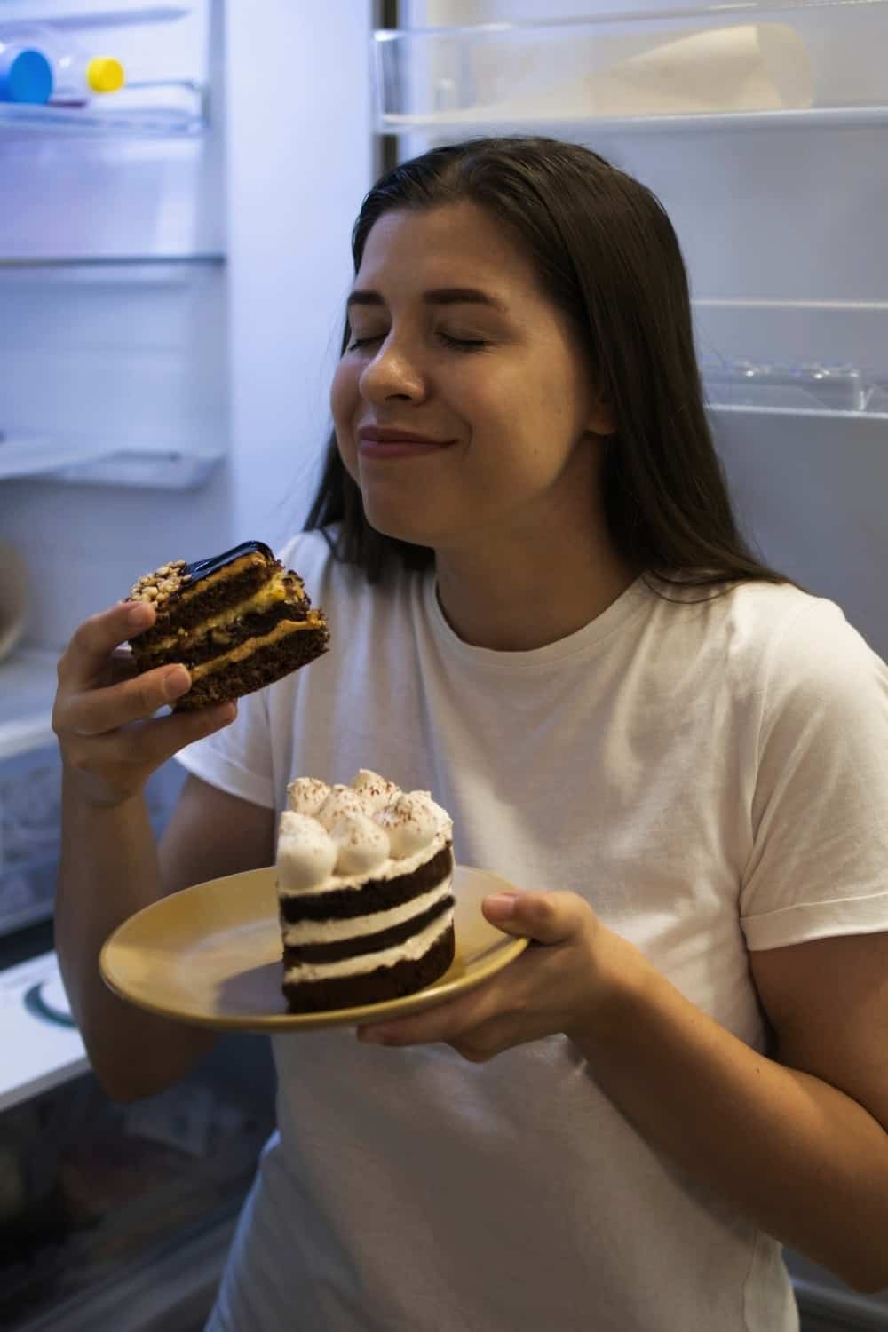 girl eating a cake from fridge