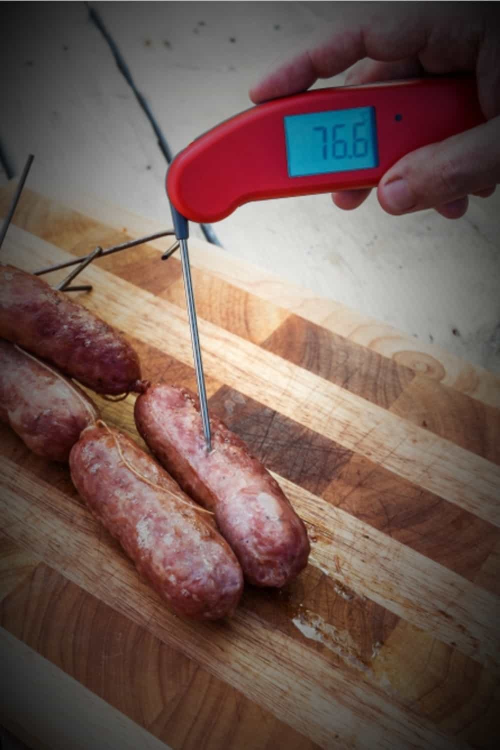 measuring the doneness of the sausage with a thermostat