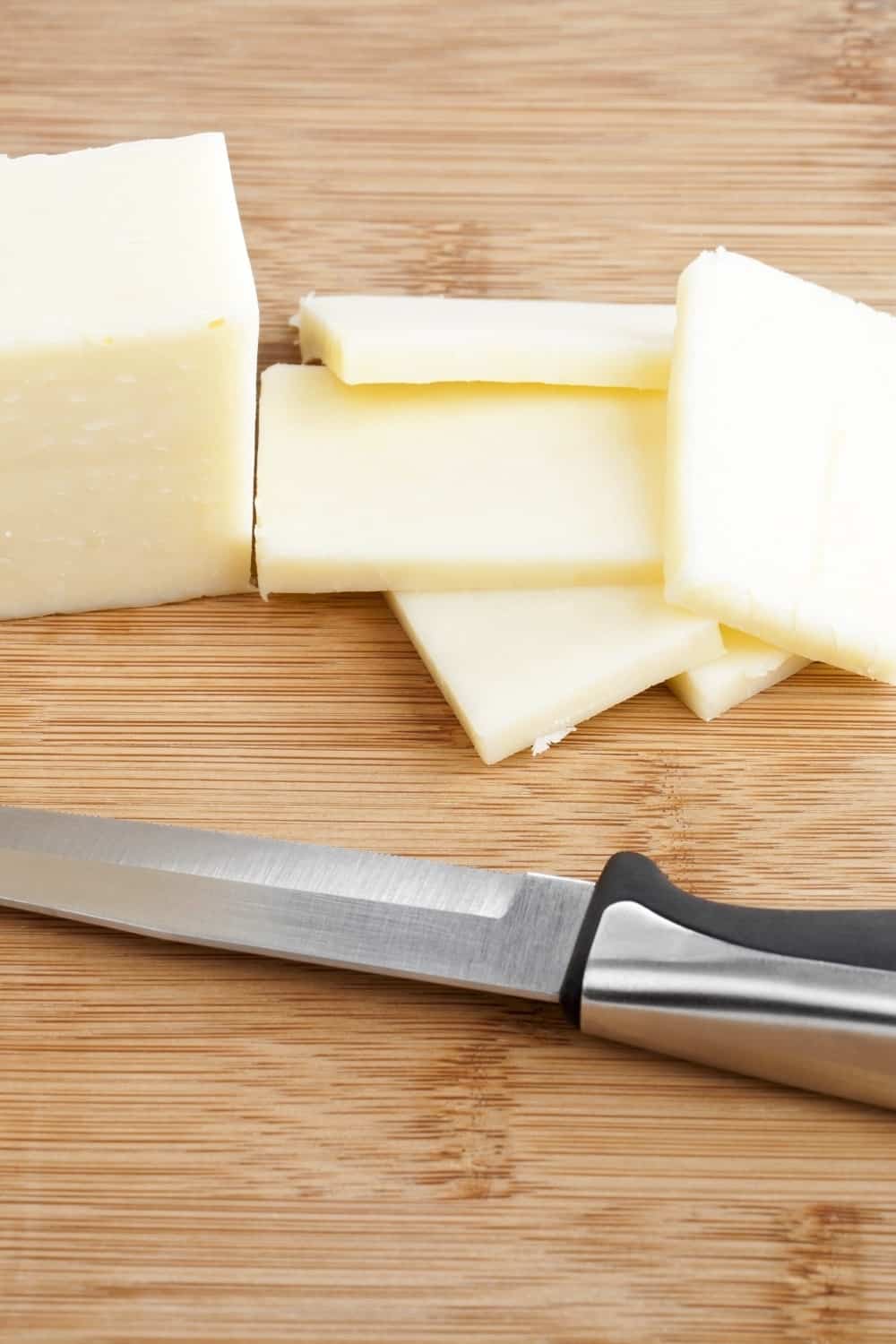 mozzarella cheese block cut with knife