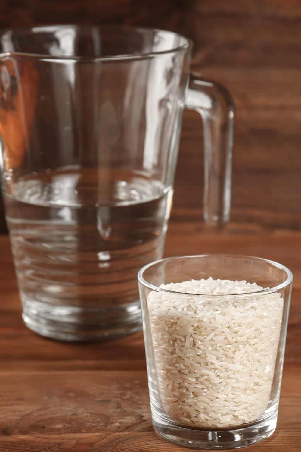 one cup of rice grains next to water