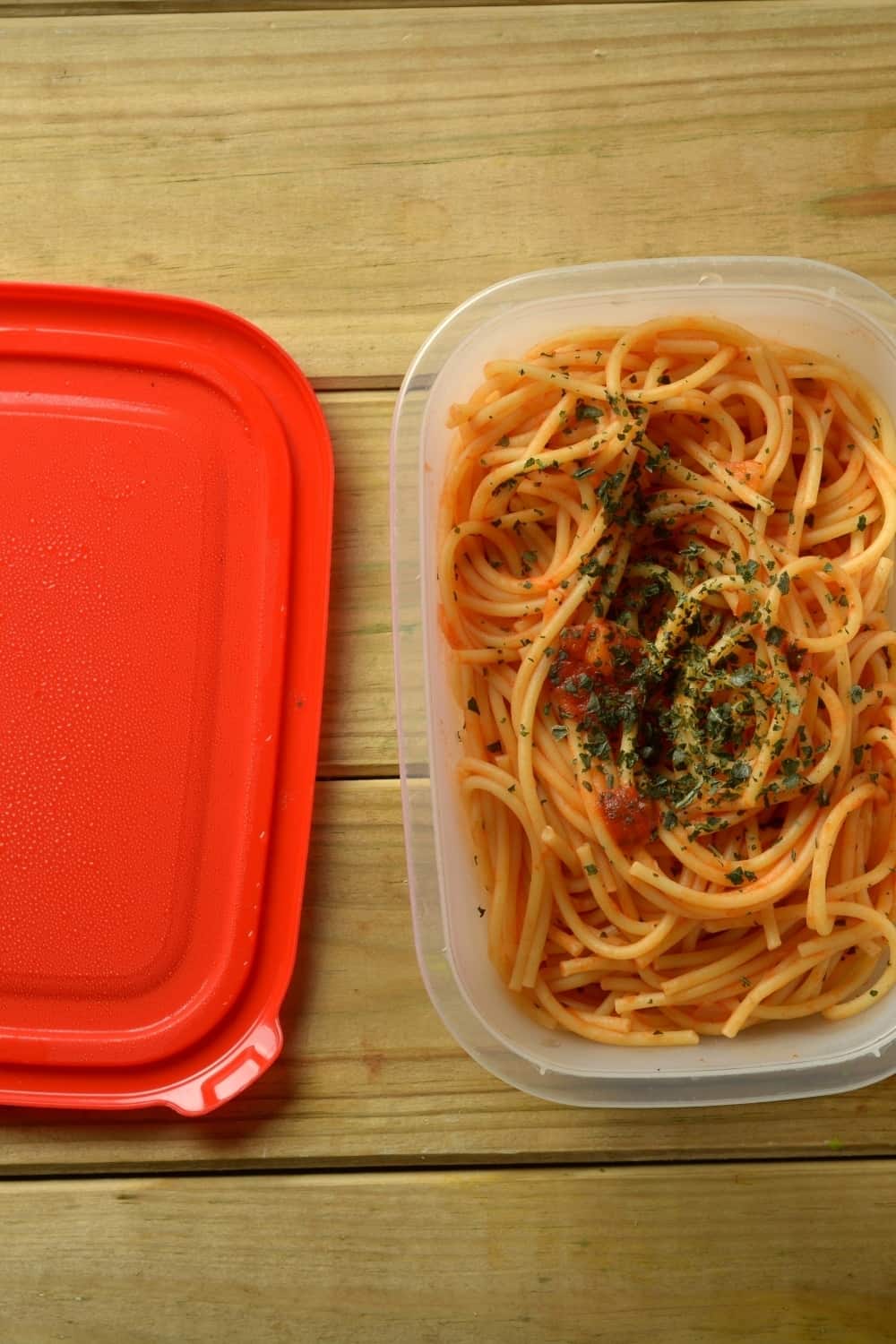 spaghetti in a plastic container, ready to be refridgerated
