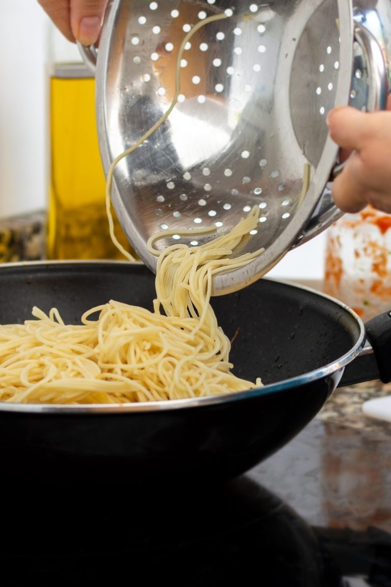 How Long Is Spaghetti Good For In The Fridge Storage Tips   Woman Pouring Drained Spaghetti Into A Pan 768x1152 