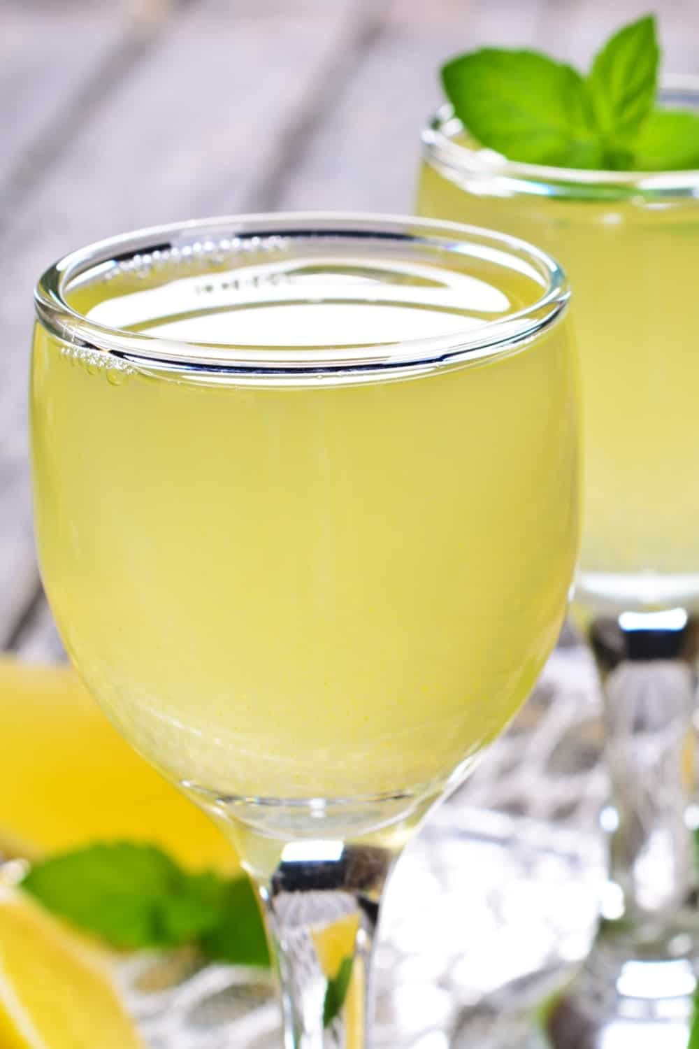 Drink of lemon in a small glass on a wooden surface