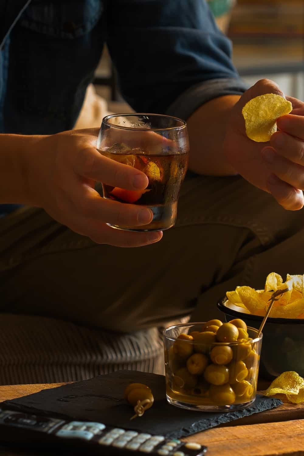 a man drinks vermouth with lemon