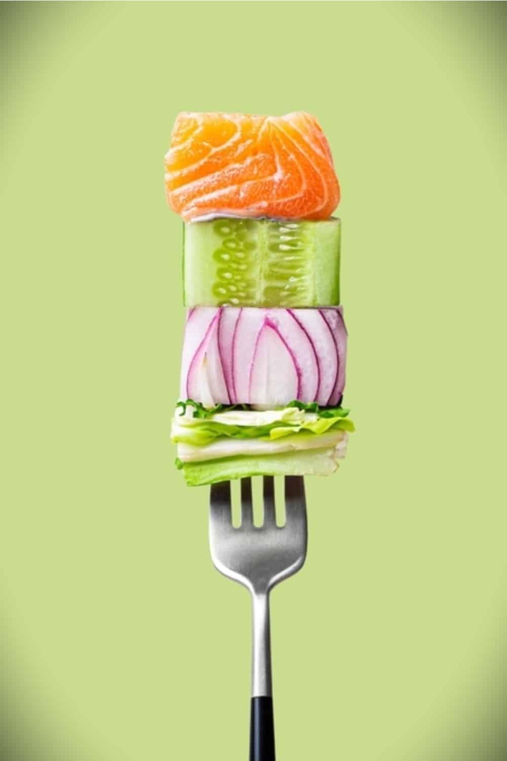 fork with salad and food on it