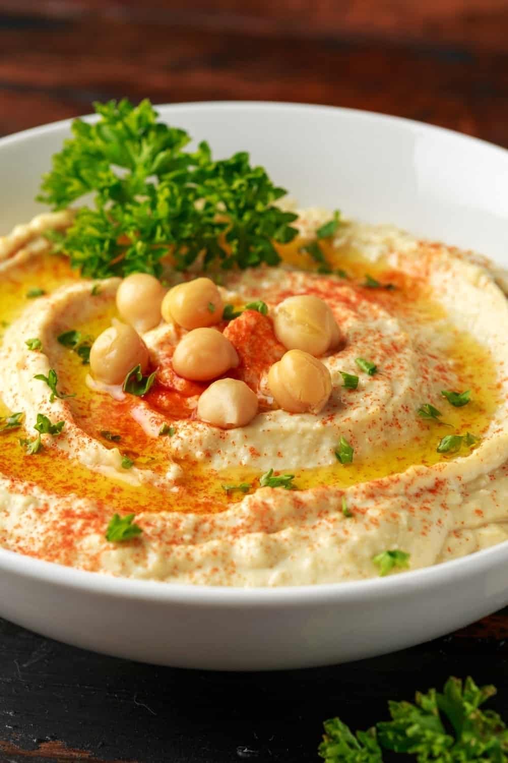 hummus in a white plate on the table